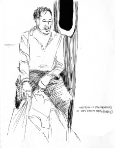 Seated male passenger holding bags.
